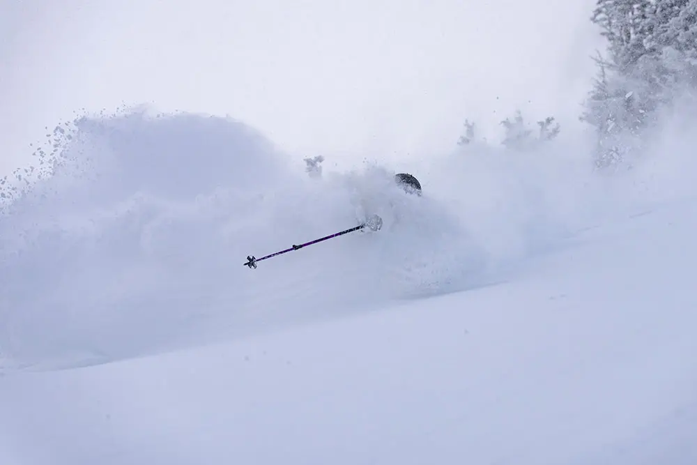 Skier in overhead powder on a storm day with the Summit Pass, a Snowbird Season Pass