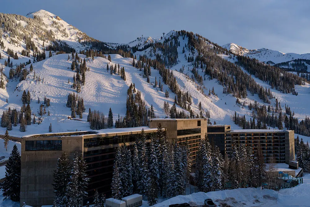 The Cliff Lodge at sunset on a bluebird day with the mountain behind it