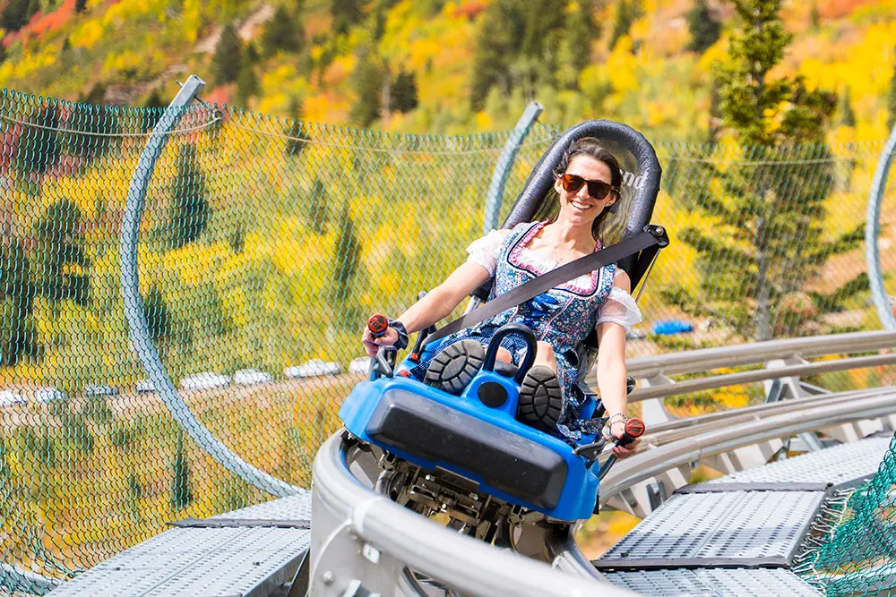 Person riding the mountain coaster at Snowbird in the fall