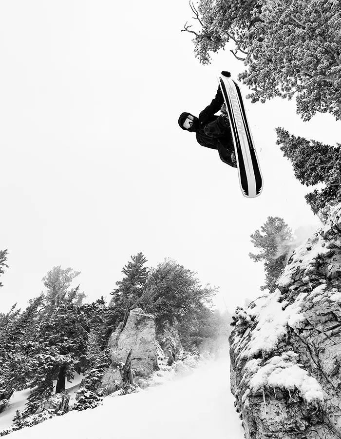 Mobile hero of a snowboarder hitting a cliff at Snowbird