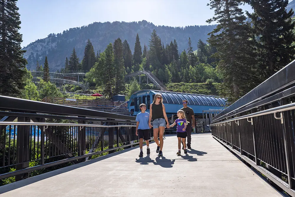 Family walks on the bridge by the Peruvian chairlift in the summer during a family reunion