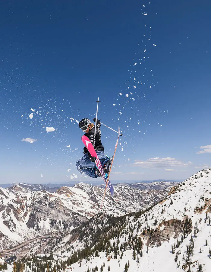 Mobile hero of a skier hitting a jump during spring