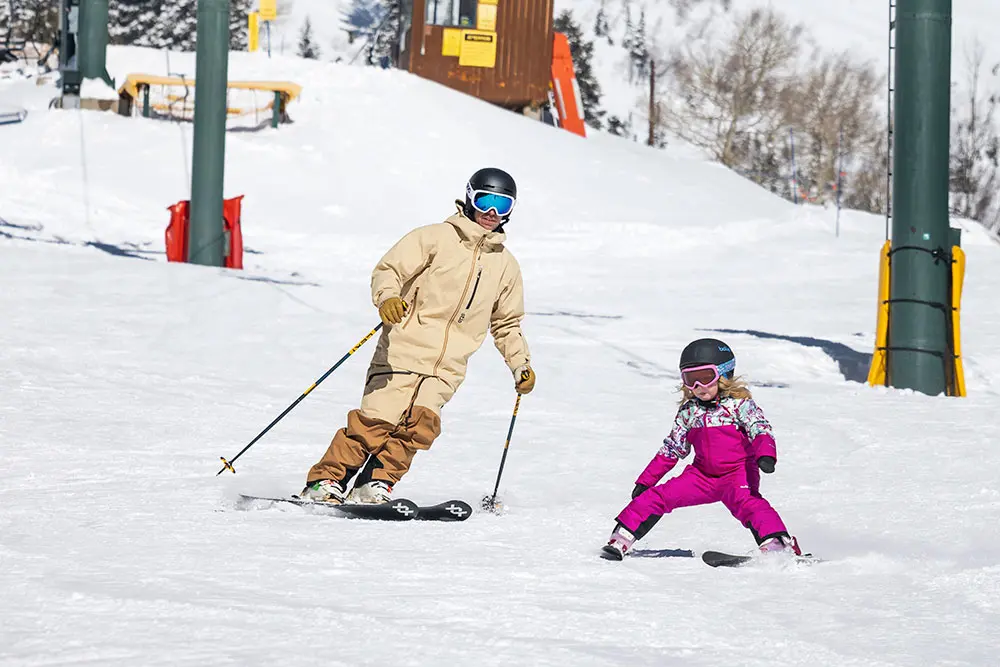 Skier on chickadee with dad - freeloader passes come with unlimited skiing at Snowbird