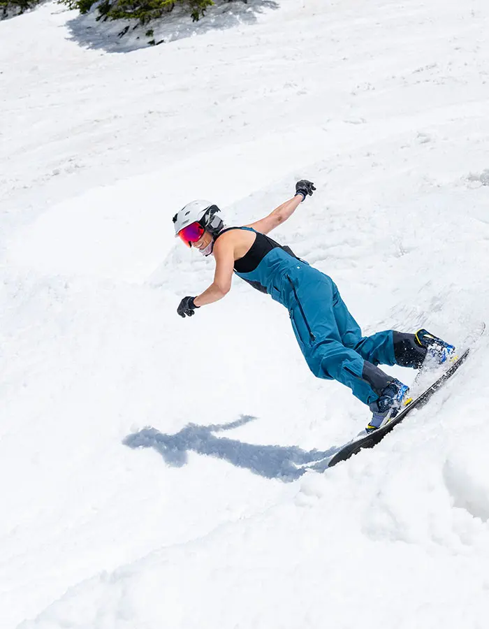 Snowboarder rides the wiggle during spring, mobile hero