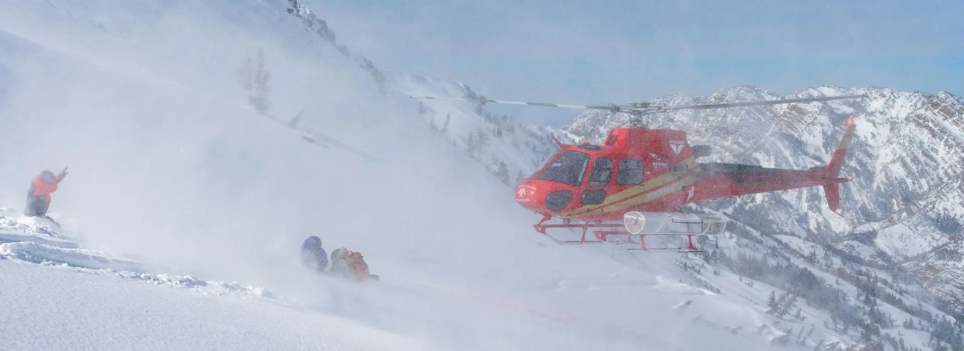 Helicopter lands at close to skiers waiting for their ride on a powderbird helicopter experience