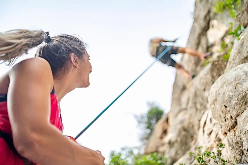 Guide belays a climber during a Rock Climbing 101 course at Snowbird