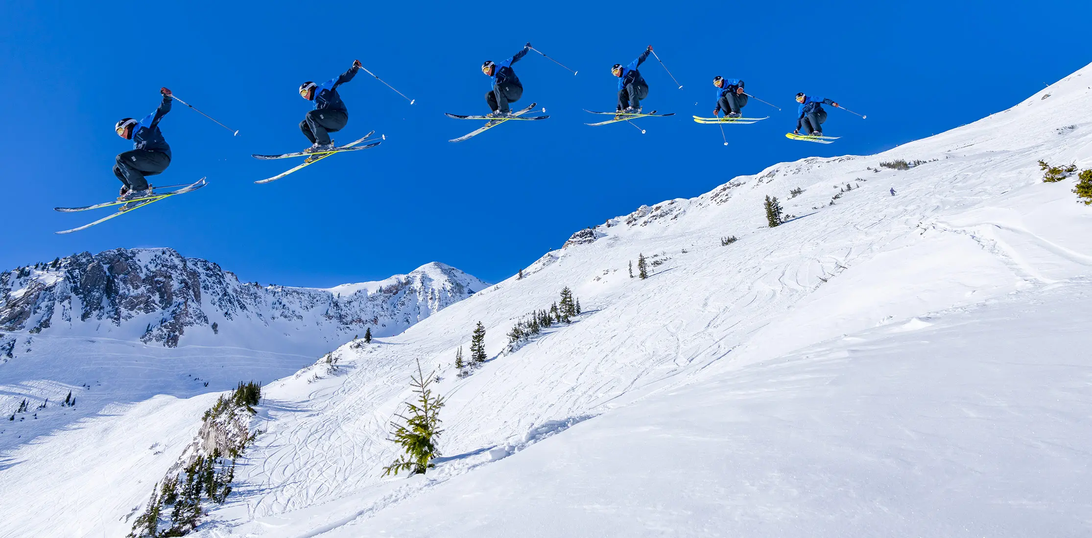 Repeating image of a skier hitting a jump in mineral basin, promo for the half-off, full-send lodging sale