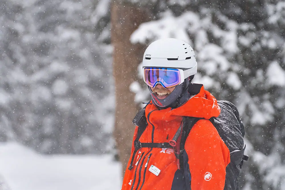 Guide with Snowbird Mountain Guide smiles during a snow storm