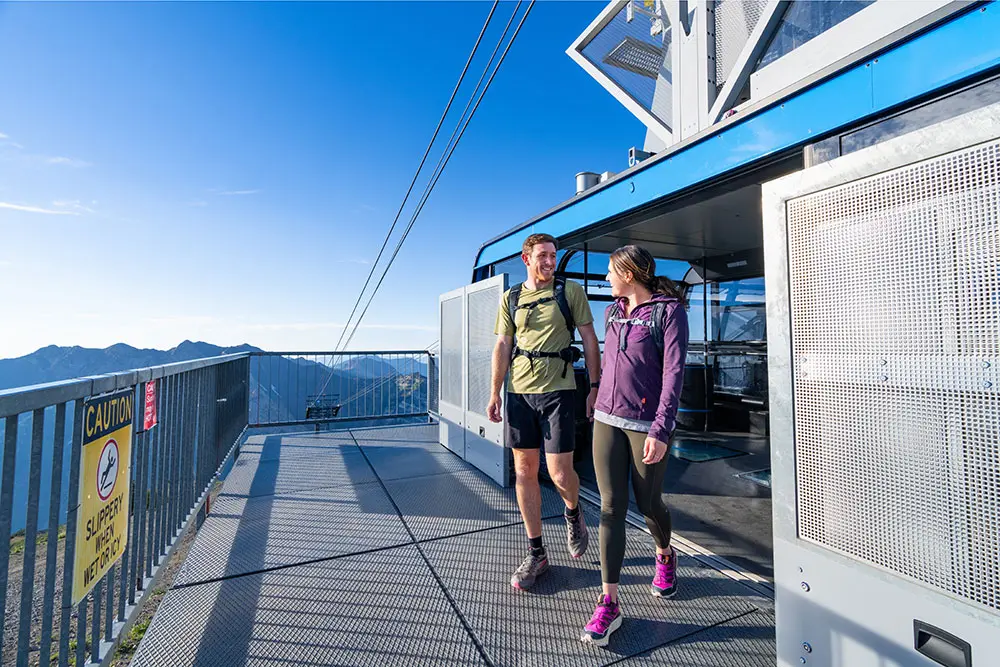 Coworkers get off a tram at Snowbird during a Corporate retreat with hiking