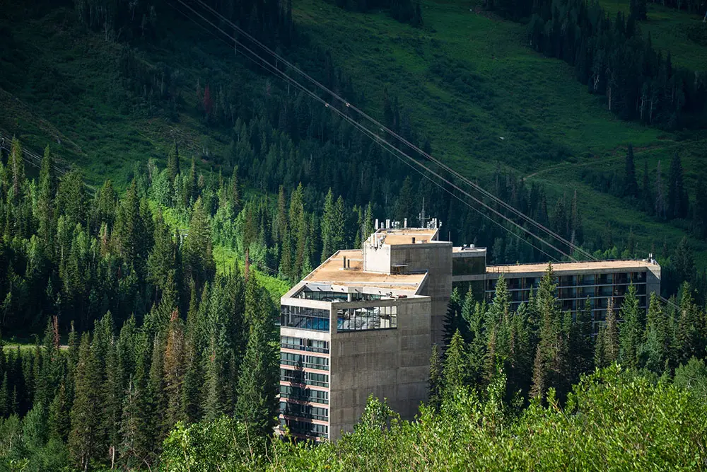 The Cliff Lodge from above, tucked into green trees at Snowbird- The Cliff Lodge is a great place for groups and conferences