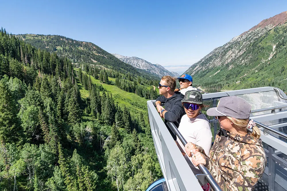 A leisure group enjoys the view from the rooftop balcony at Snowbird