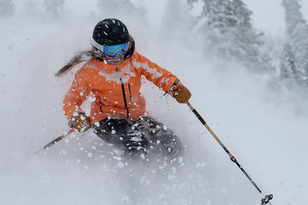 Skier in deep powder at Snowbird smiling