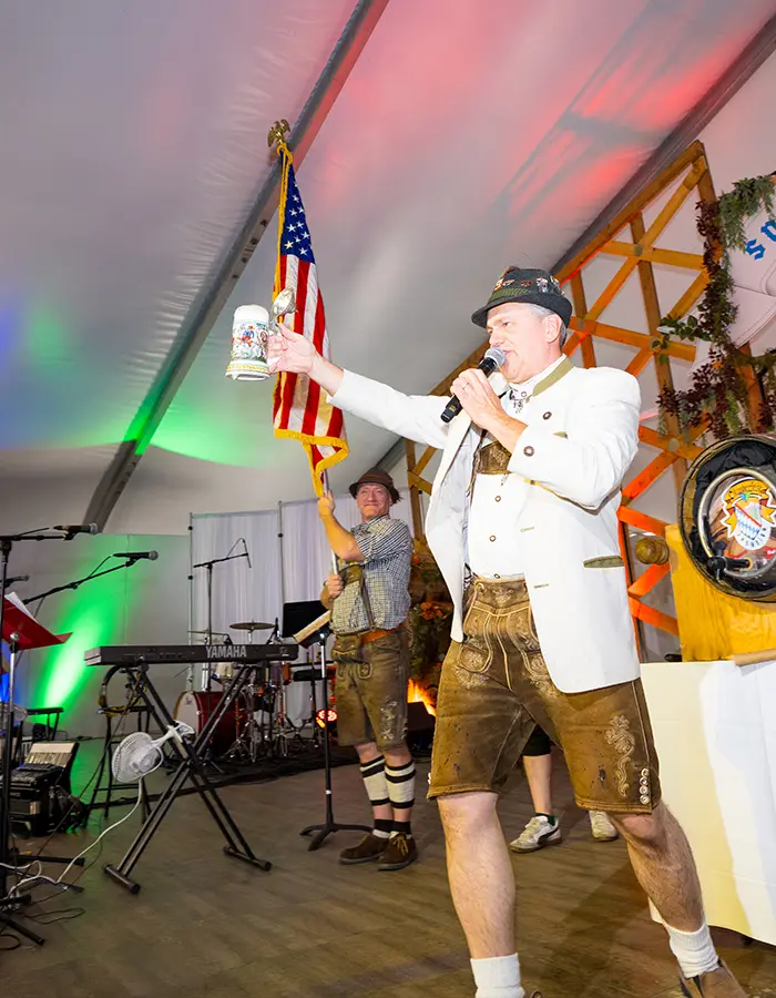 Person holding up a beer at Snowbird's oktoberfest, one of the many fall events