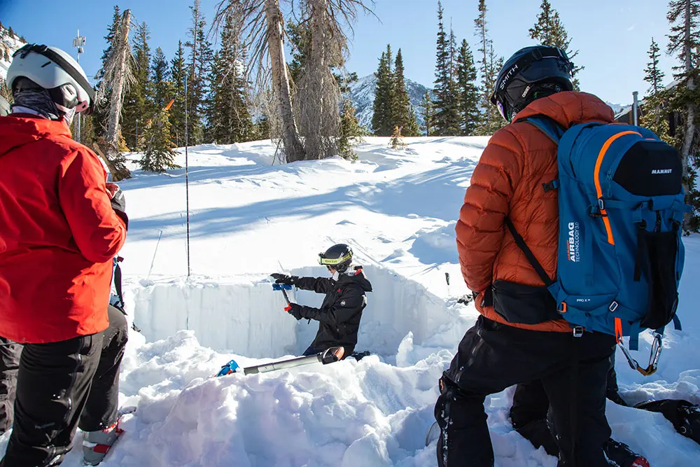 AIARE 1 Refresher Course with Snowbird Mountain Guides- Guide digs a pit and demonstrates shovel tapping to test stability