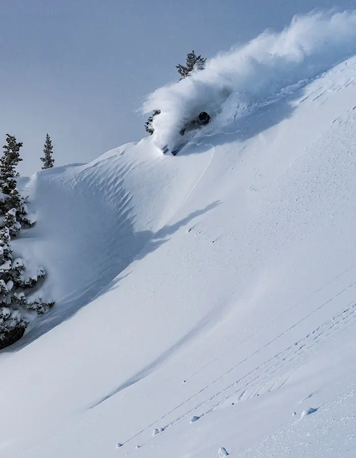mobile hero of skier in powder on a ridgeline