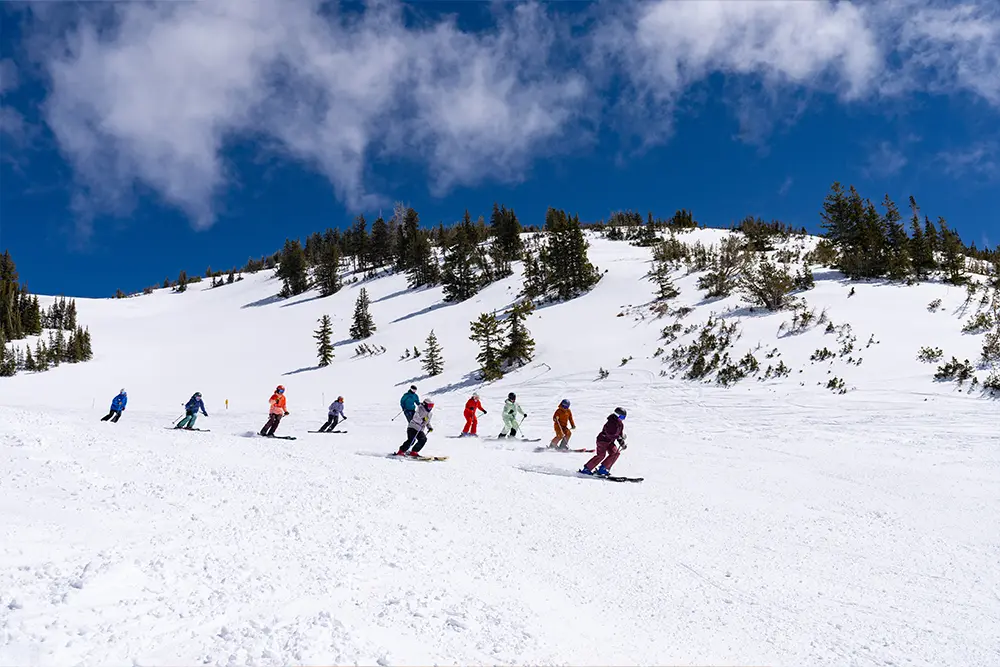 Snowbird ladies shred together during a group ride in Women's Ski Week