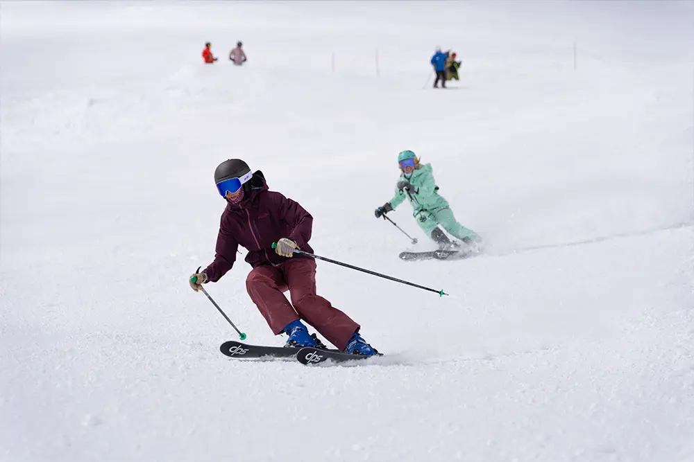 Women skiing together at Snowbird during a group ride