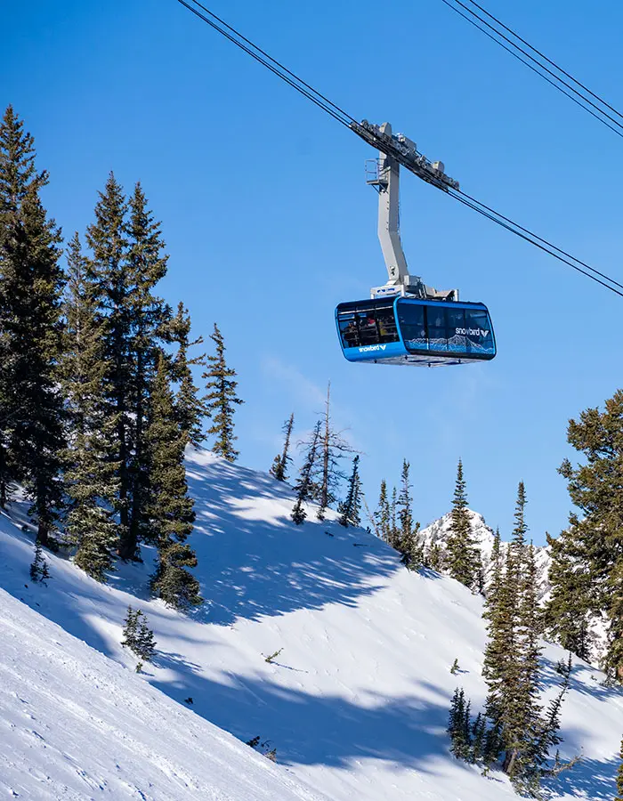 Tram rising above the mountains on a sunny day at Snowbird