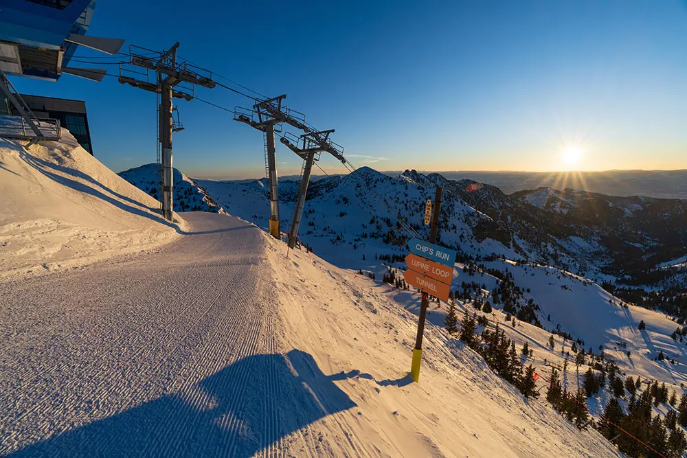Sunrise behind Mineral Basin lift at Snowbird