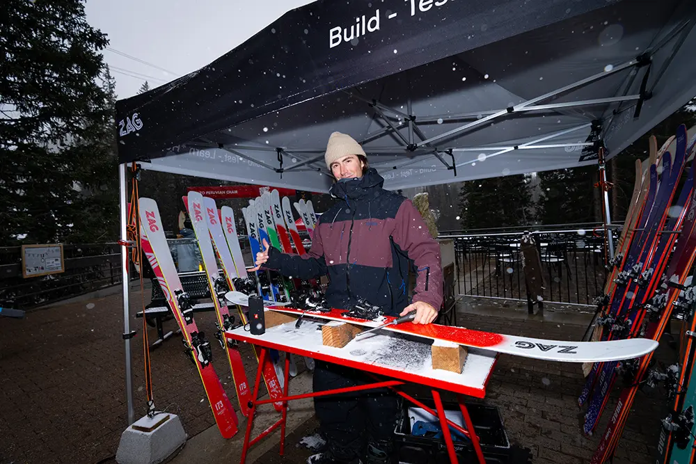 Representative poses with a ski he's working on in a demo tent at the Blister Summit at Snowbird