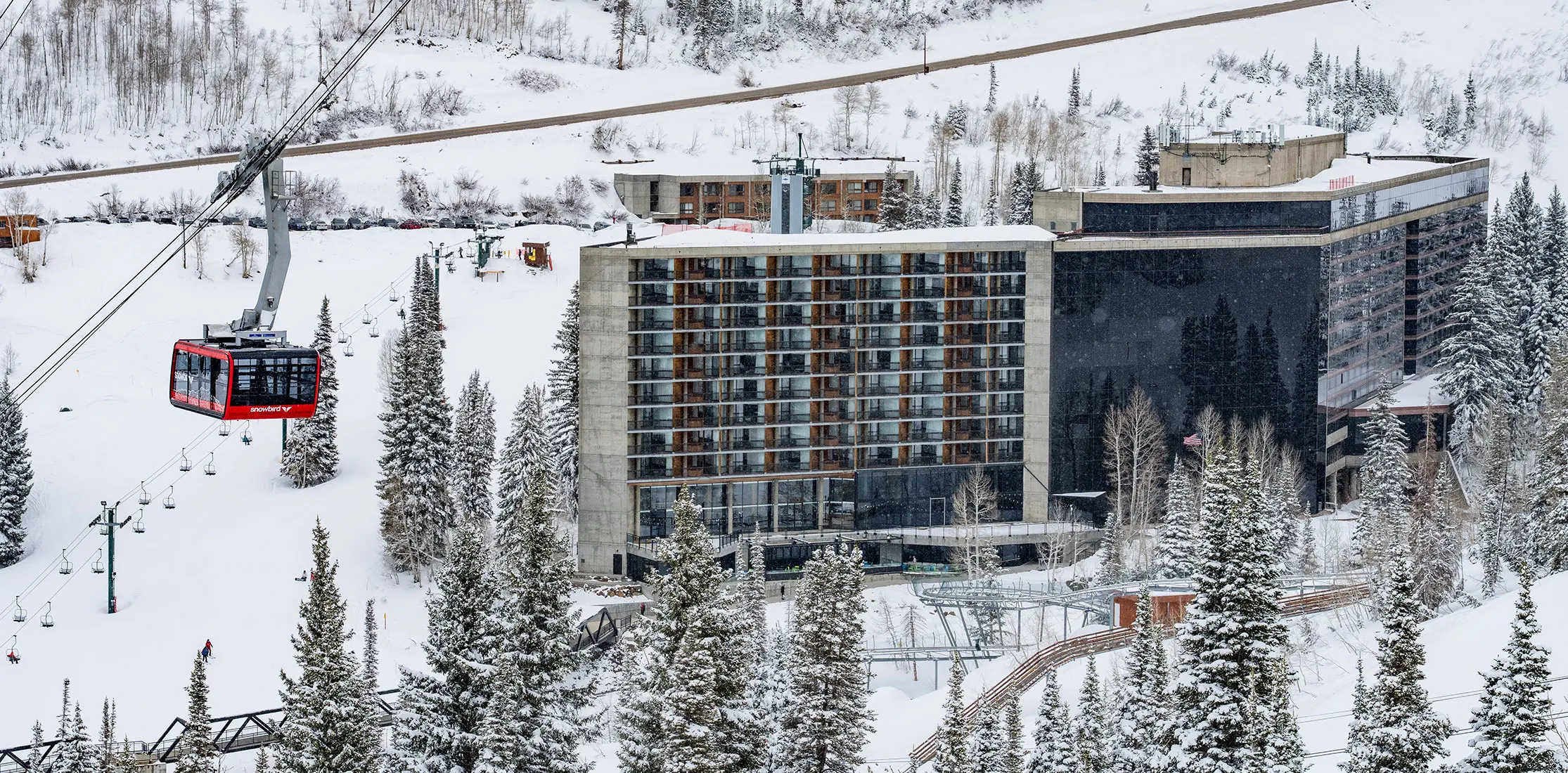 Tram rises next to The Cliff Lodge at Snowbird
