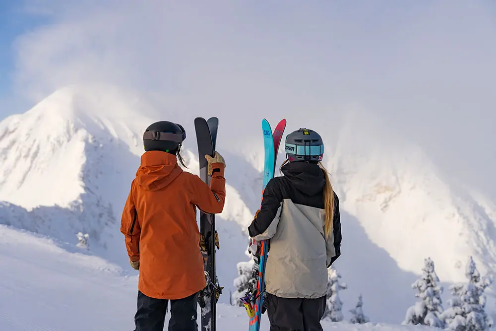 Girls look out at the twin peaks at Snowbird during ski like a girl event at Snowbird