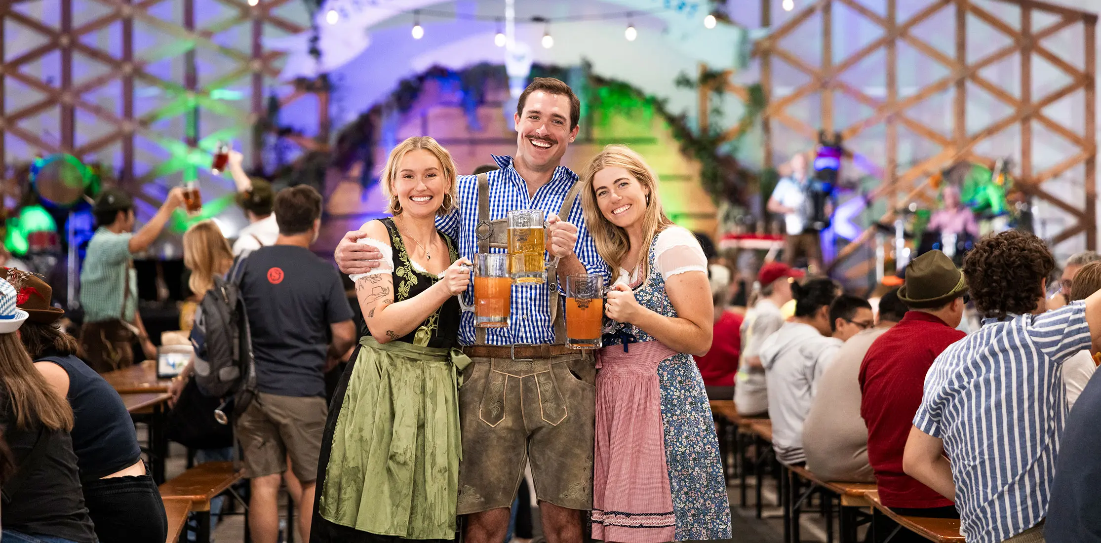 Friends smile and cheers beer at Oktoberfest at Snowbird
