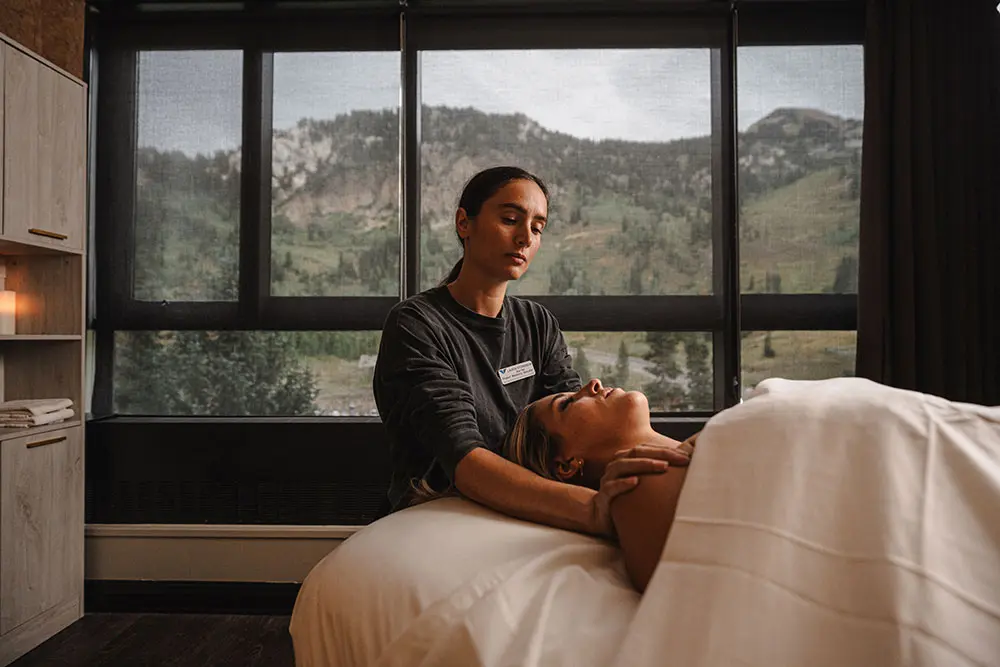 Technician gives a massage at The Cliff Spa at Snowbird
