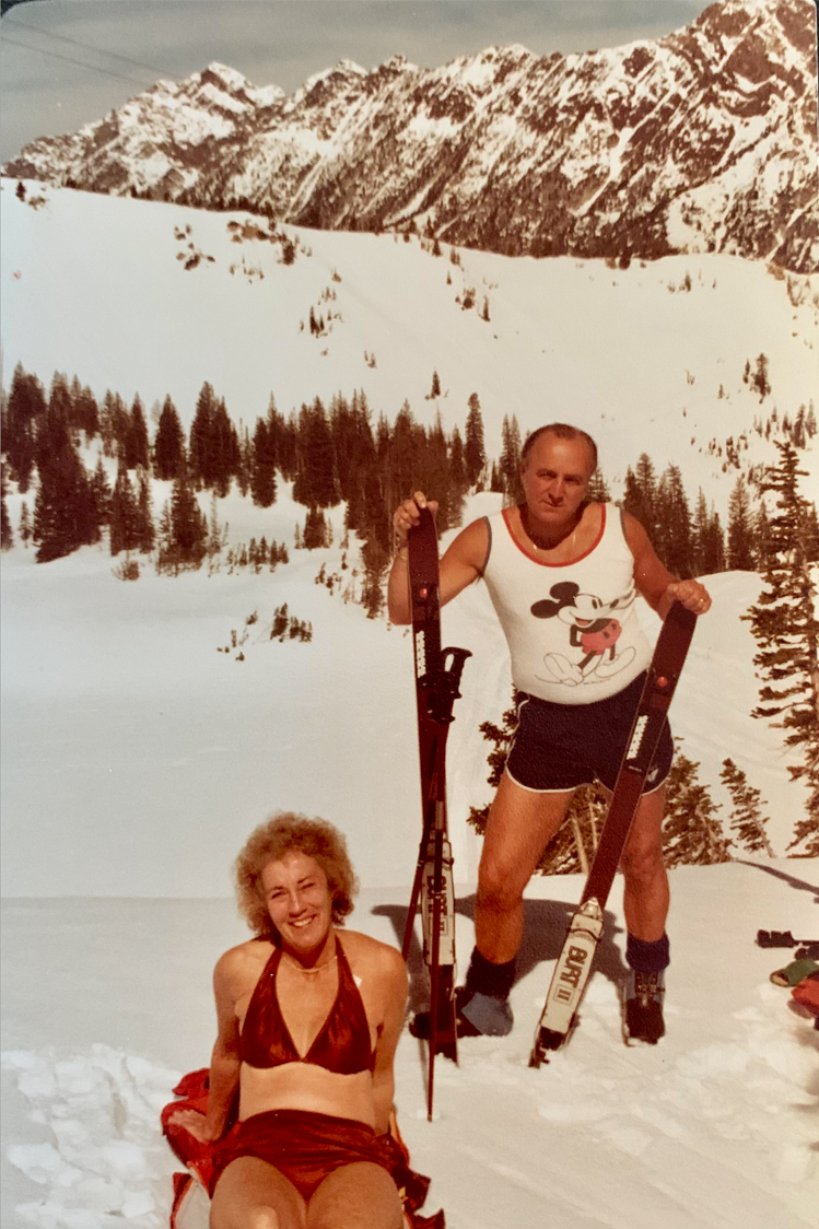 A lady in a bathing suite and a man in a tank top on the mountain