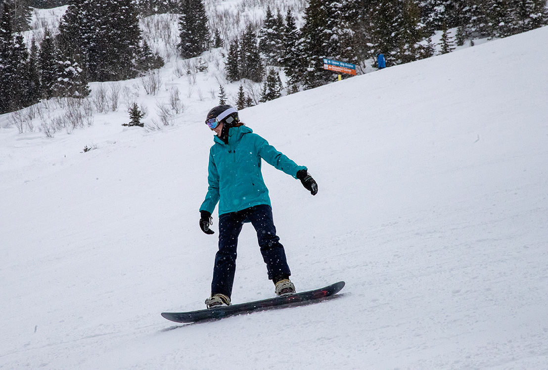 Intermmediate snowboarder at Snowbird taking a lesson