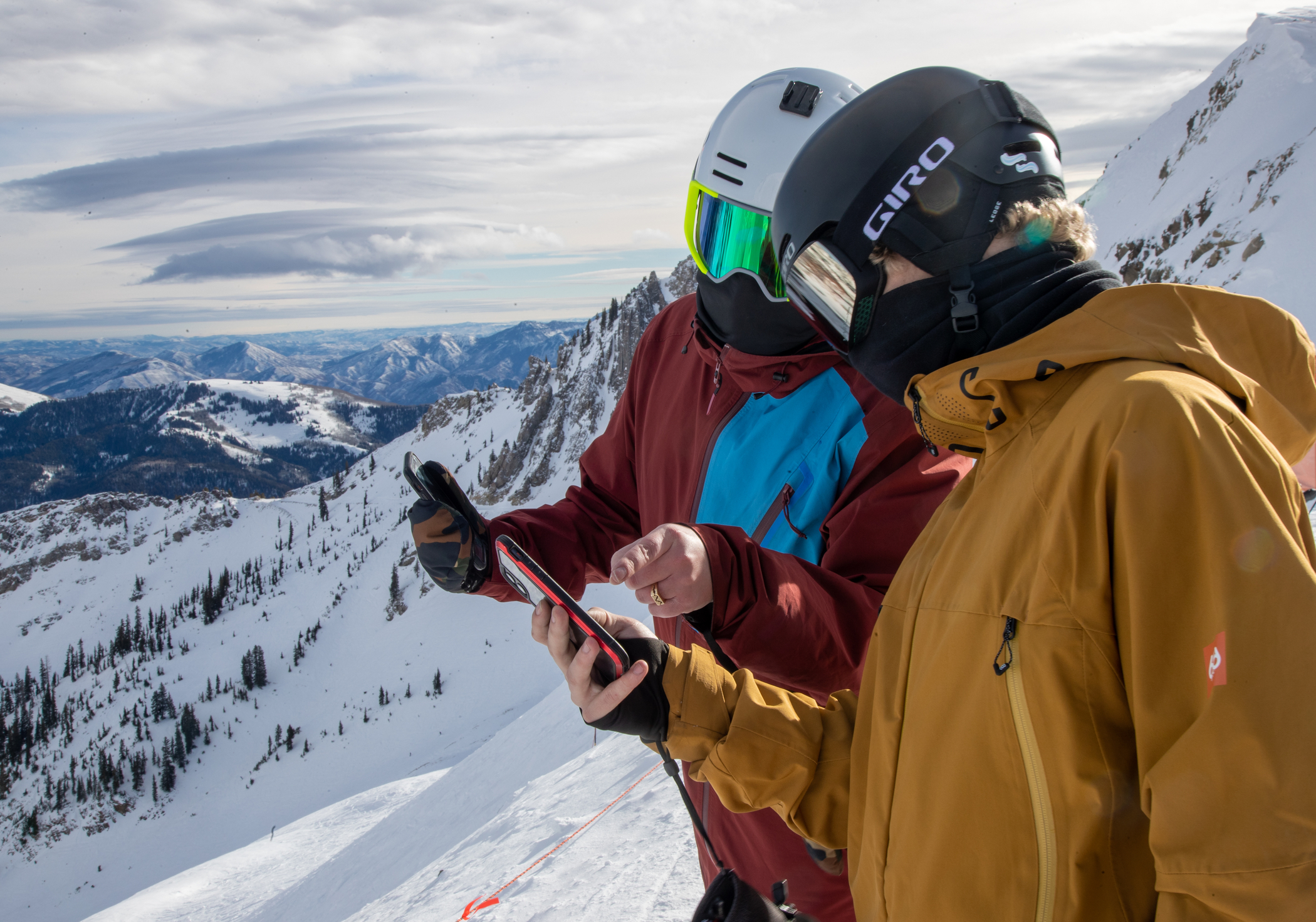 Two guys looking at the Snowbird App at the top of the mountain