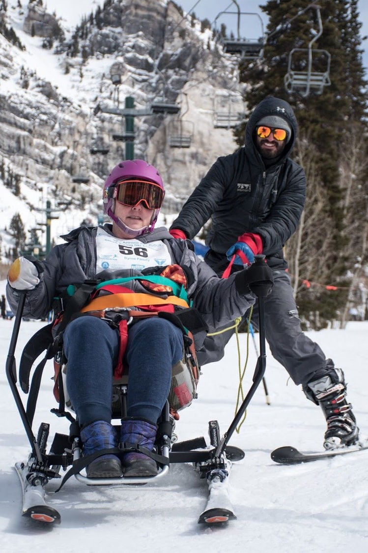 Snowbird Athlete, Justin Latimer instructing with Wasatch Adaptive Sports, mom in sit-ski