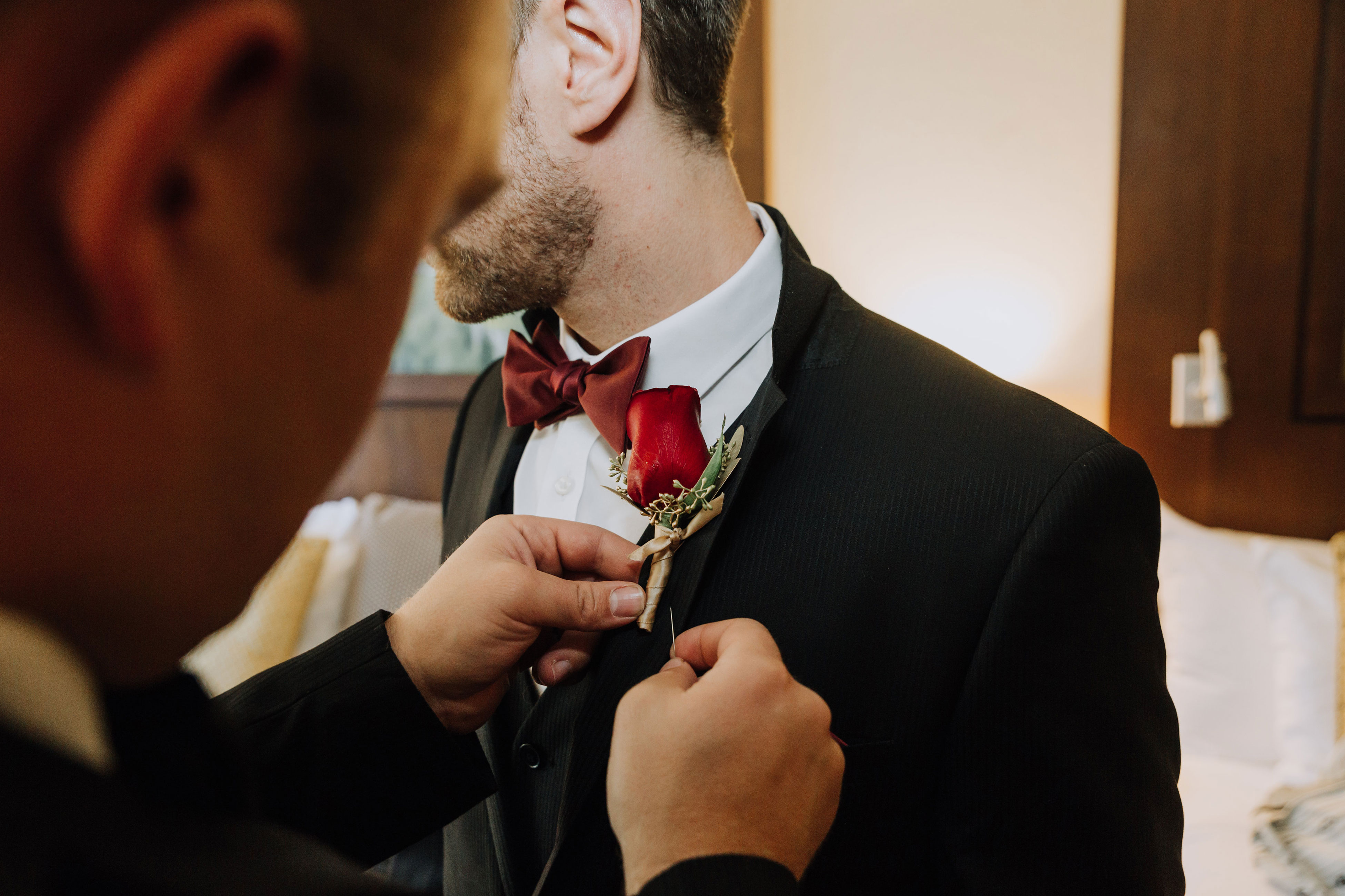 groom getting dressed at one of Snowbird's mountain wedding venues